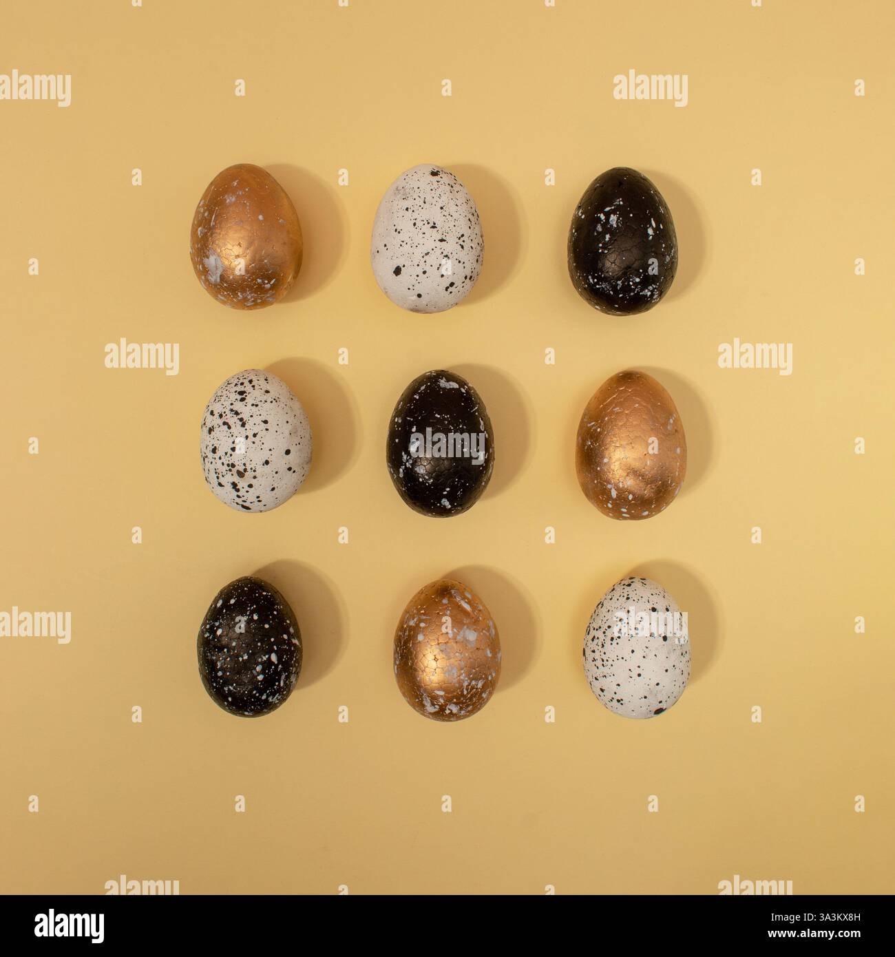 Pattern made of colored eggs on pastel beige background. Minimal Easter concept. Stock Photo