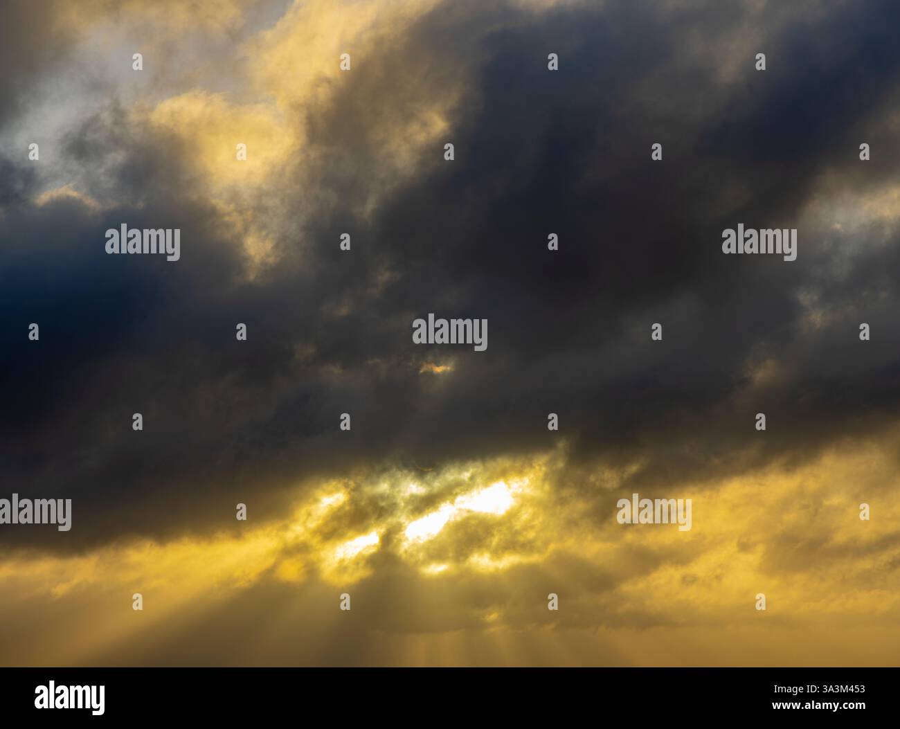 wild sunset in dark clouds Stock Photo