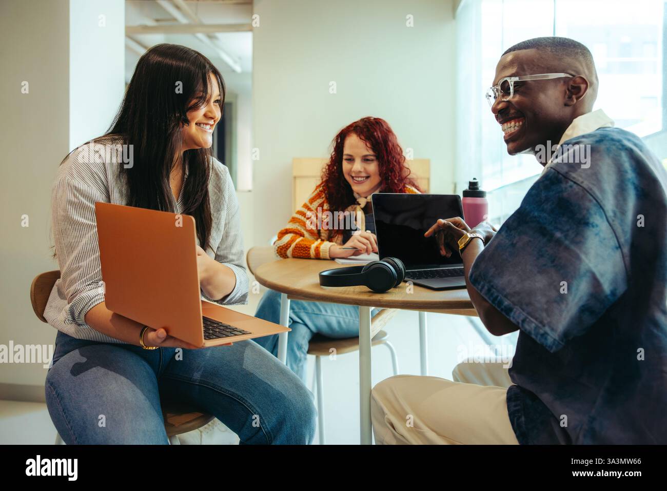 High school students engage in teamwork and creativity while collaborating on a project in a study session with laptops. Stock Photo