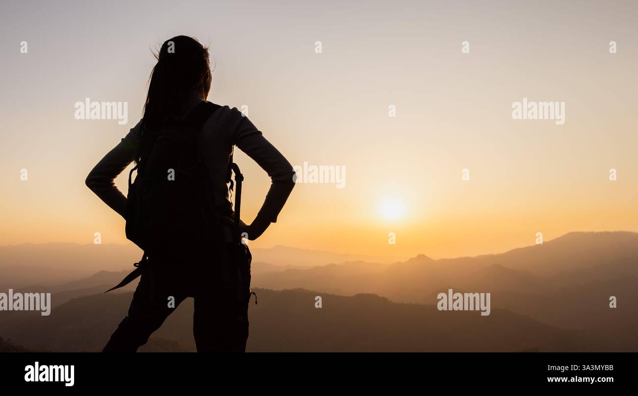 Silhouette of A person standing on top of the mountain Travel and ...