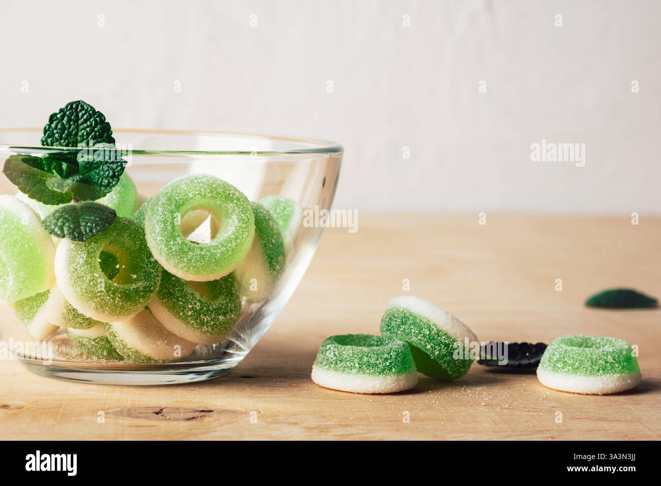 Green chewy candy rings in glass bowl Stock Photo - Alamy