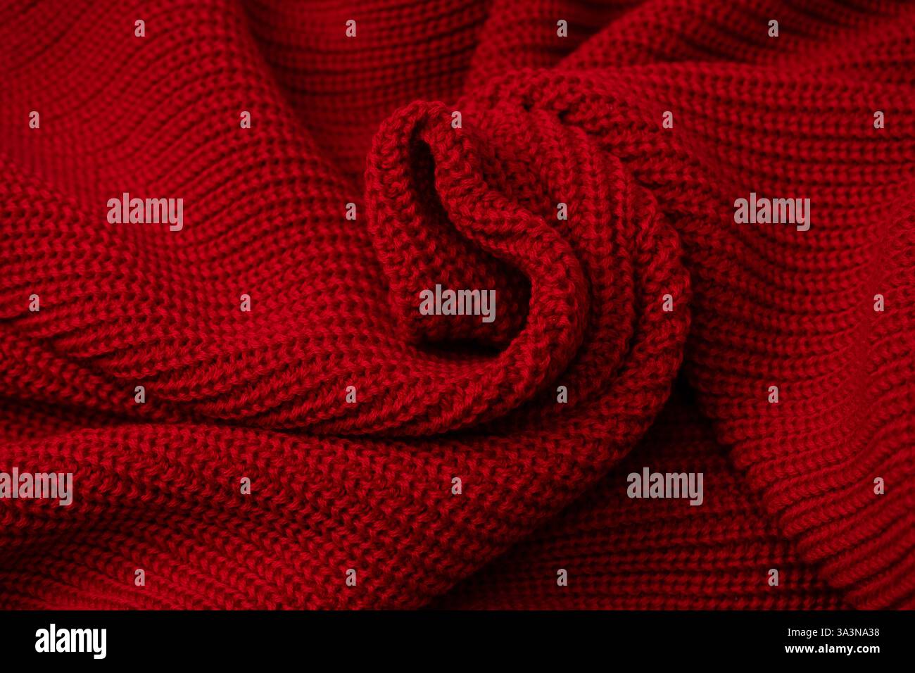 Red sweater texture as a background. Top view Stock Photo