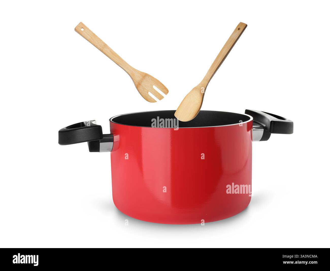 Wooden spoon and turner over saucepan on white background Stock Photo ...