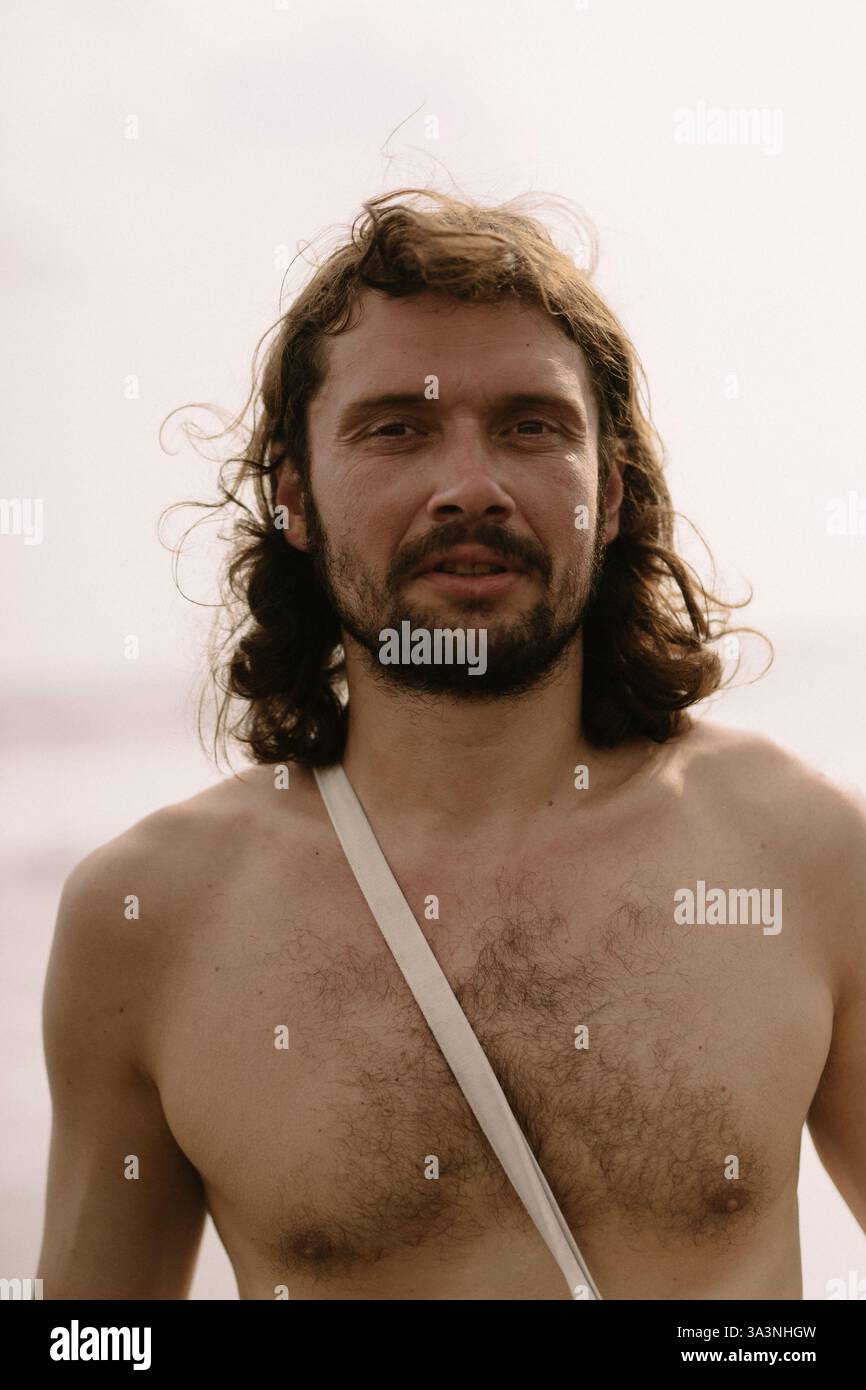 Portrait of a charismatic man with long, curly hair. Stock Photo