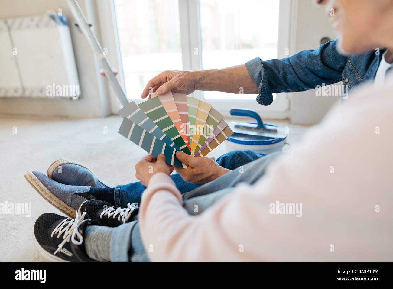 View of Couple choosing paint colors for their home renovation project Stock ...