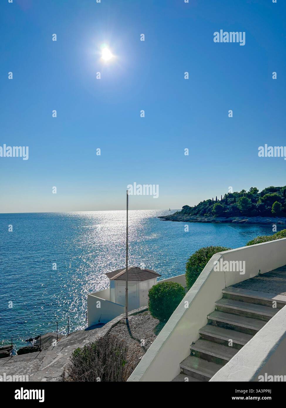 Stairs leading down to the crystal-clear sea in Pula, Istria, Croatia. A scenic coastal path offering breathtaking views. - Smartphone Captured Stock Image