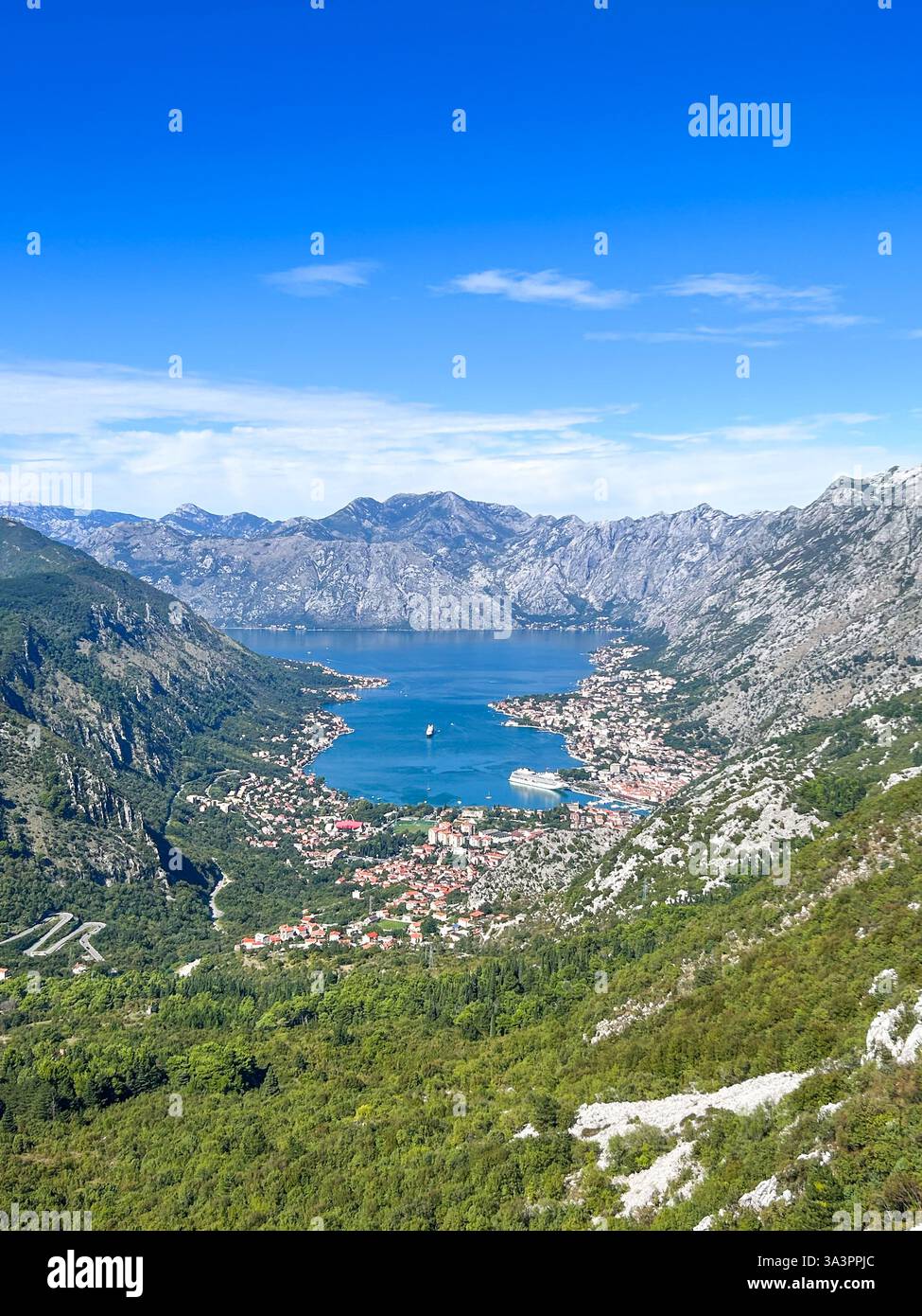 A breathtaking view of Kotor and the Bay of Kotor, with historic rooftops, winding coastal landscapes, and the shimmering Adriatic Sea. - Smartphone Captured Stock Image