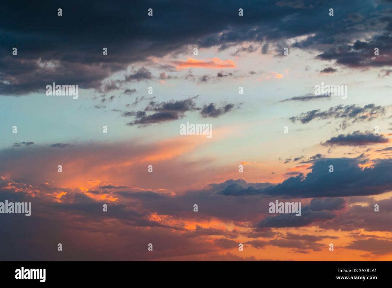 Partly cloudy sky at sunset. Dramatic clouds on the sky. Stock Photo