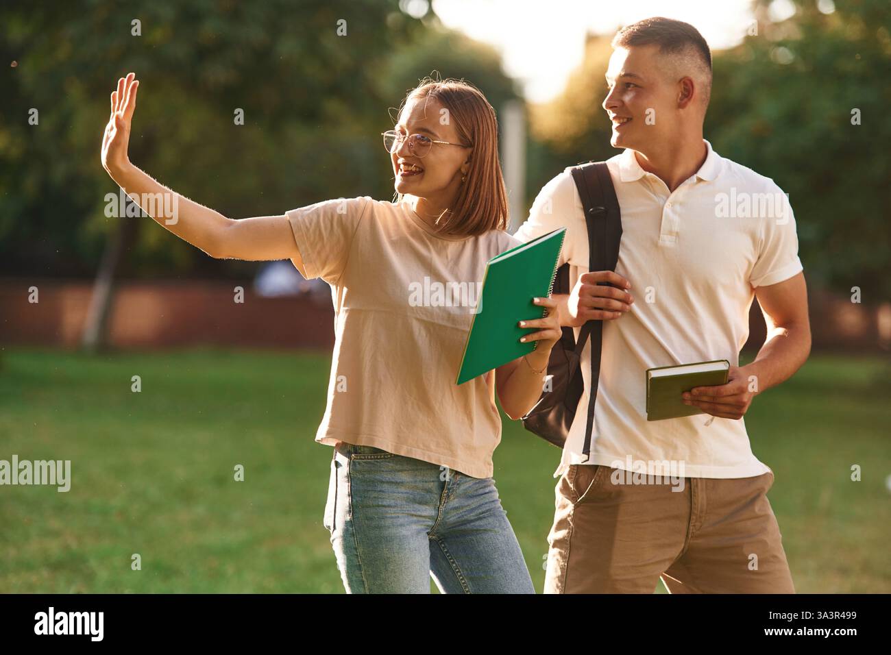 Two students are together outdoors. Stock Photo