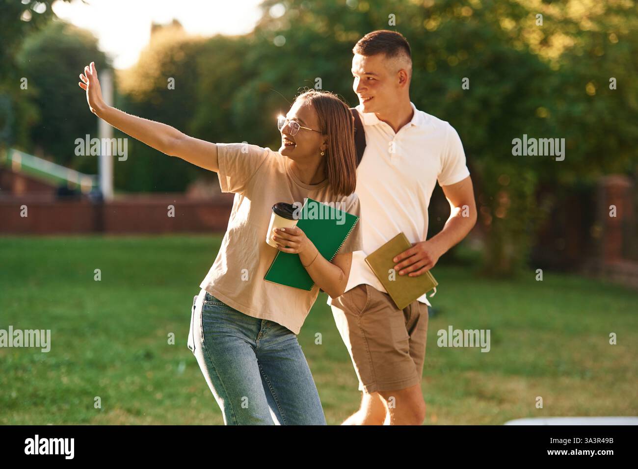 Two students are together outdoors. Stock Photo