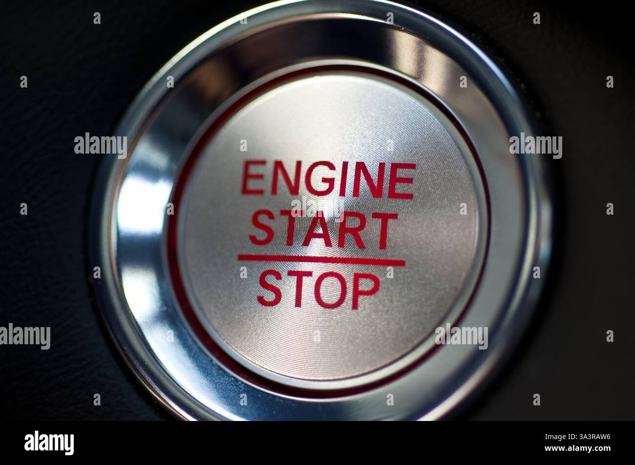Modern Vehicle Start Stop Engine Button with Red Letters on Black Horizontal Stock Photo