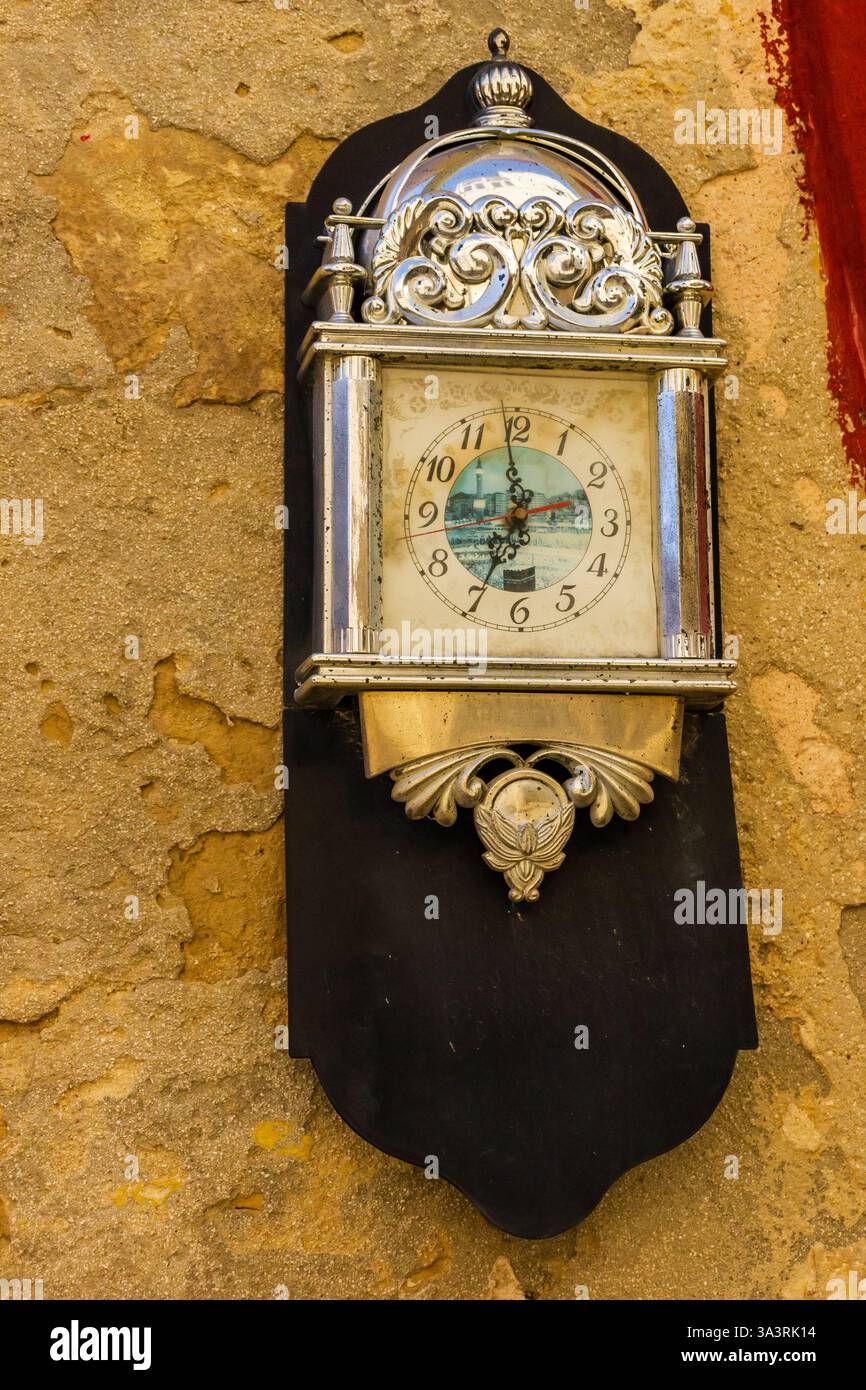 Vintage Wall Clock With Ornamental Silver Plating on Rustic Background Stock Photo