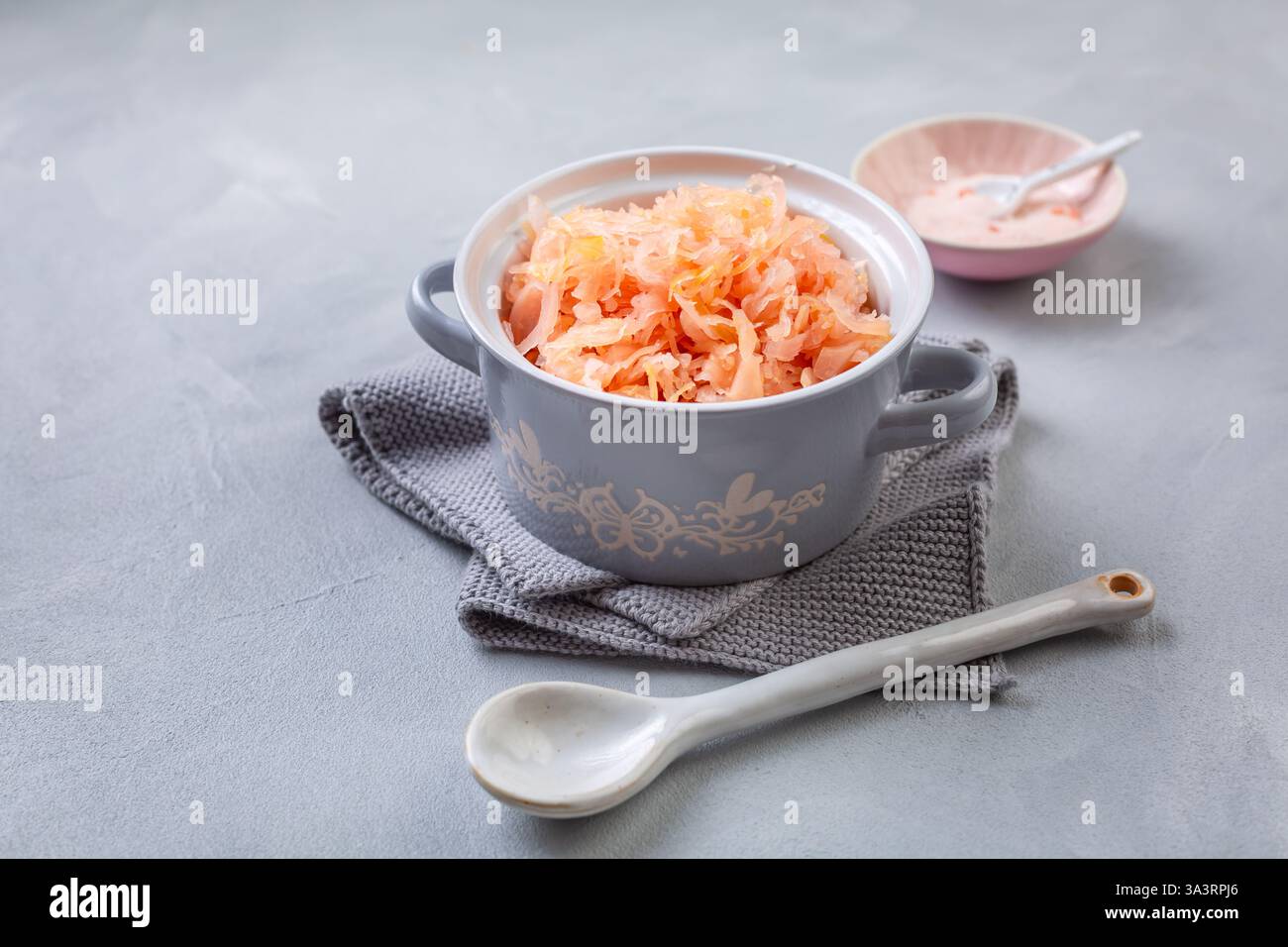 Fermented cabbage or sauerkraut in a  pot with salt Stock Photo