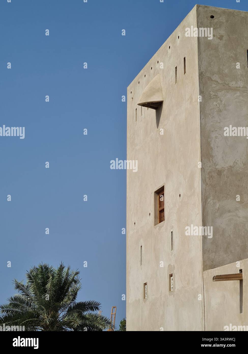 Beige Arabic Building Facade in front of a Clear Blue Sky - Smartphone Captured Stock Image