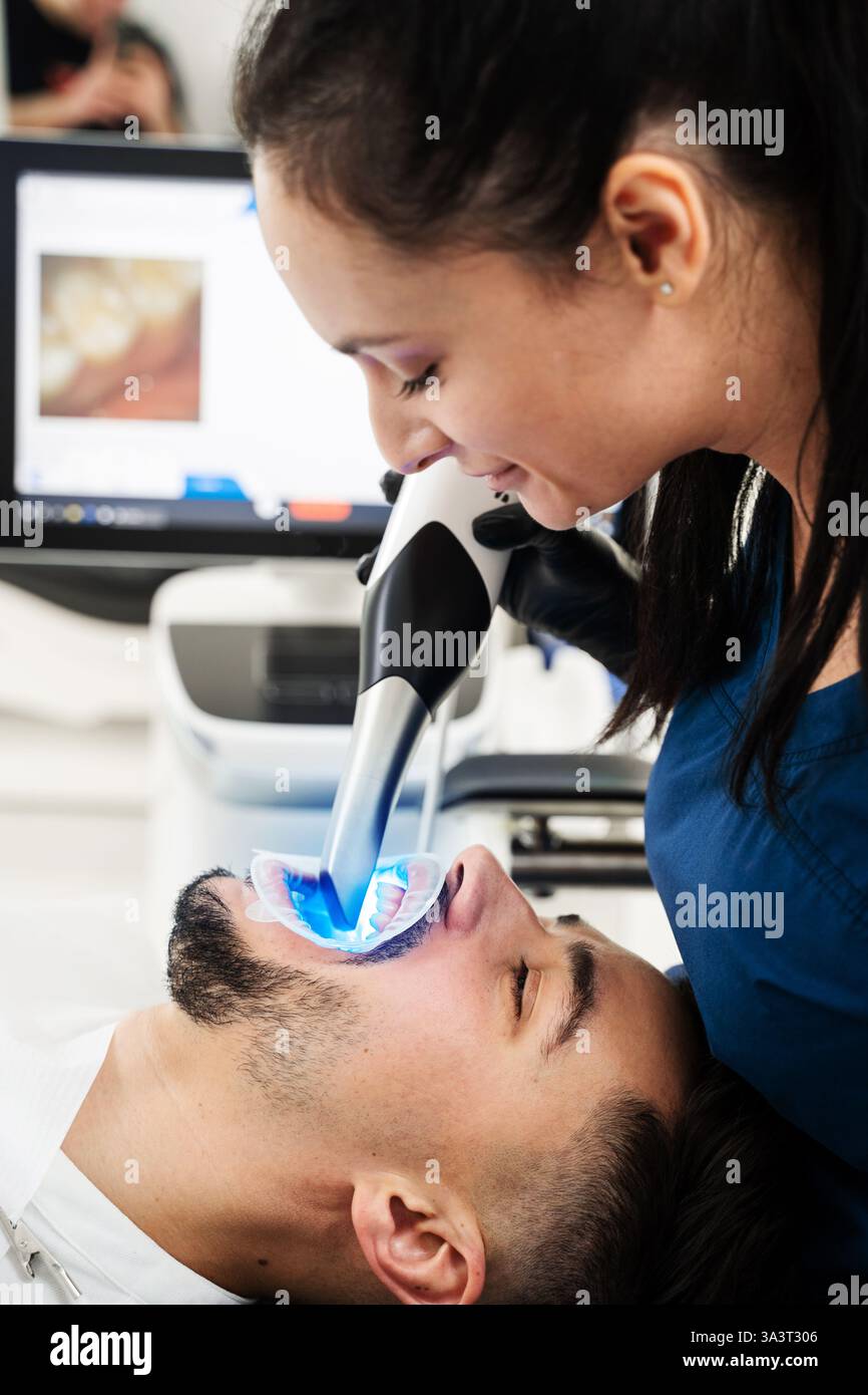 Digital teeth scanning process. Dentist uses dental scanner to examine ...