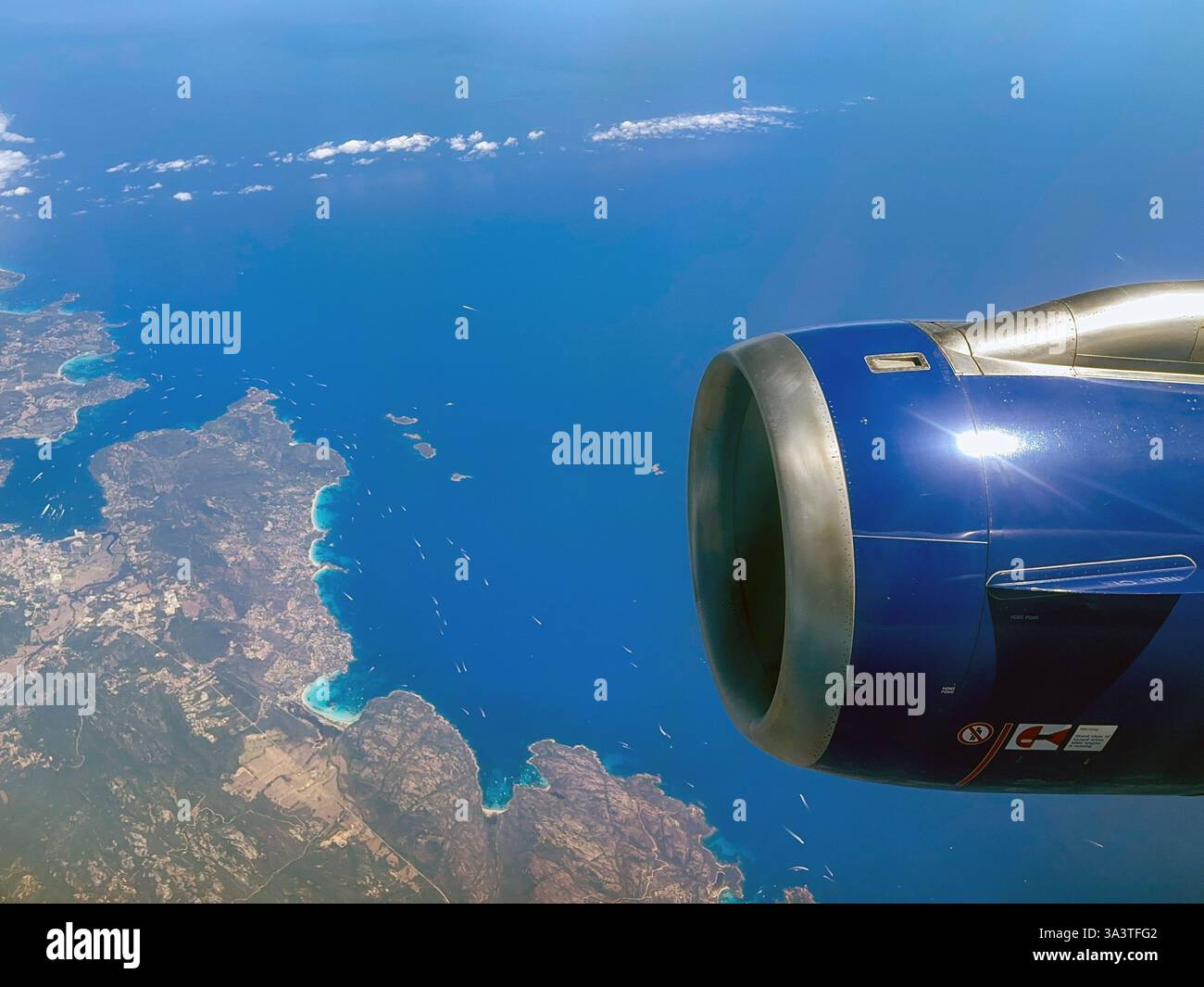 En route Malta to London - 9 August 2023: Scenic view of the coastline of Europe and a jet engine from a window seat in a holiday jet. - Smartphone Captured Stock Image