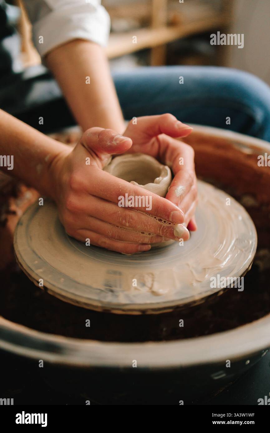 Potter creates a ceramic bowl in the pottery studio. Process of making ...