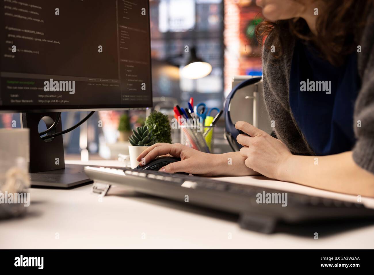Female developer coding cloud computing applications on pc in a modern ...