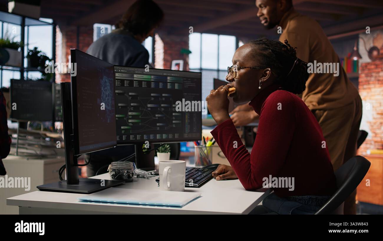 Sluggish Employee Technician eating croissant in company hi-res stock photography and ...
