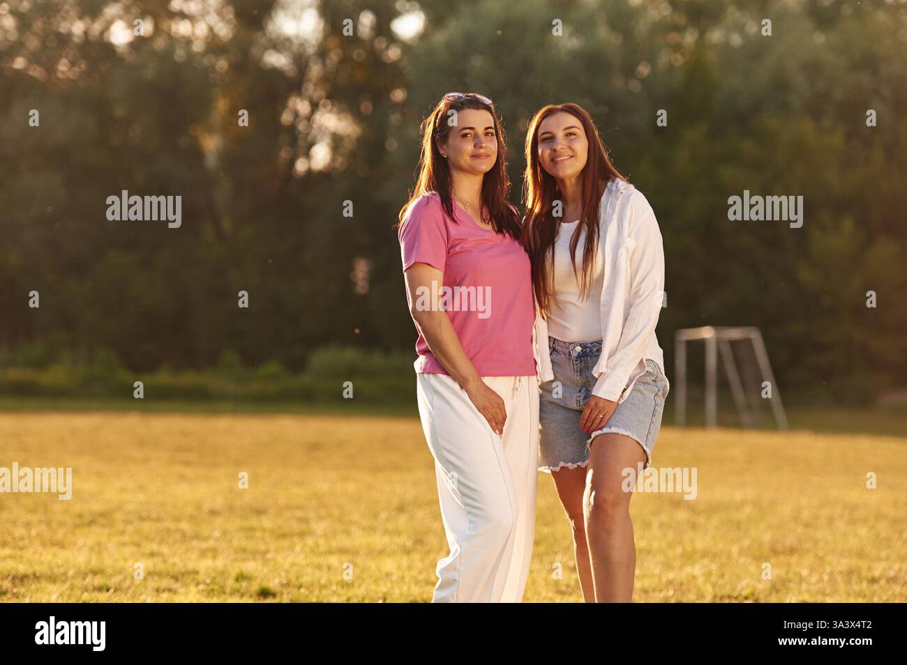 Two women standing together hi-res stock photography and images - Alamy