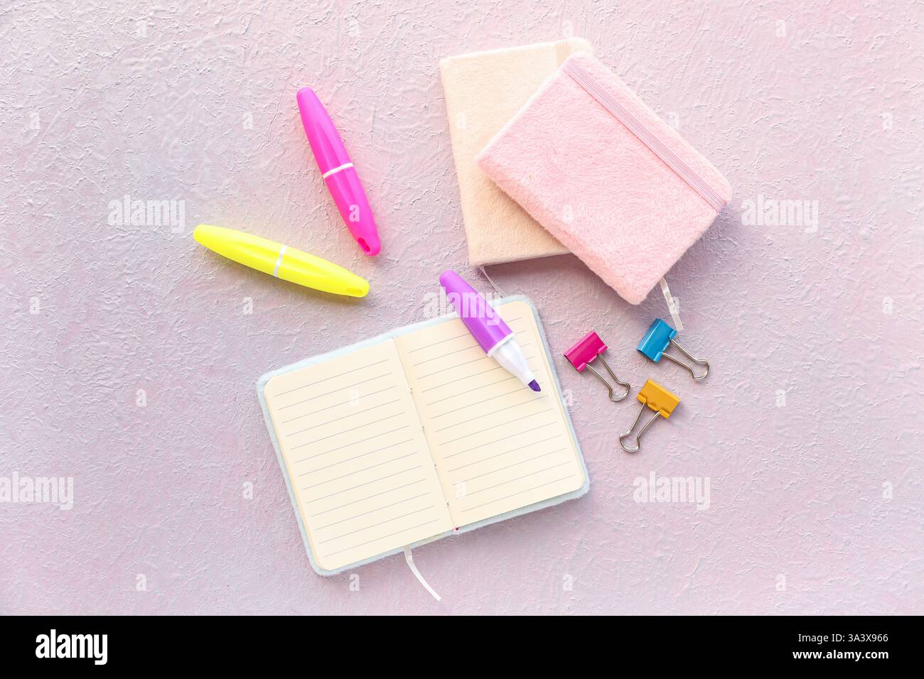 Composition with notebooks, markers and binder clips on light background Stock Photo