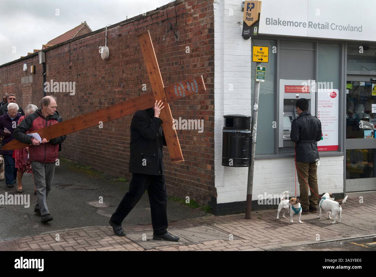 An Easter Good Friday Procession of Witness works its way around Crowland. Very few people attend this multi faith Christians Together in Crowland group. Crowland, Lincolnshire, England 30th March 2018 2010s HOMER SYKES Stock Photo