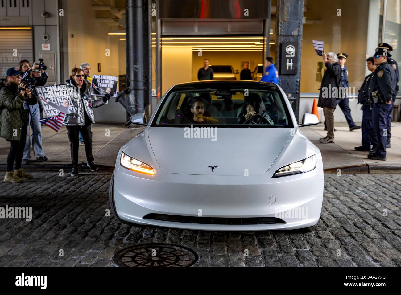 NEW YORK, NEW YORK - MARCH ?13: A person drives a Tesla from a ...