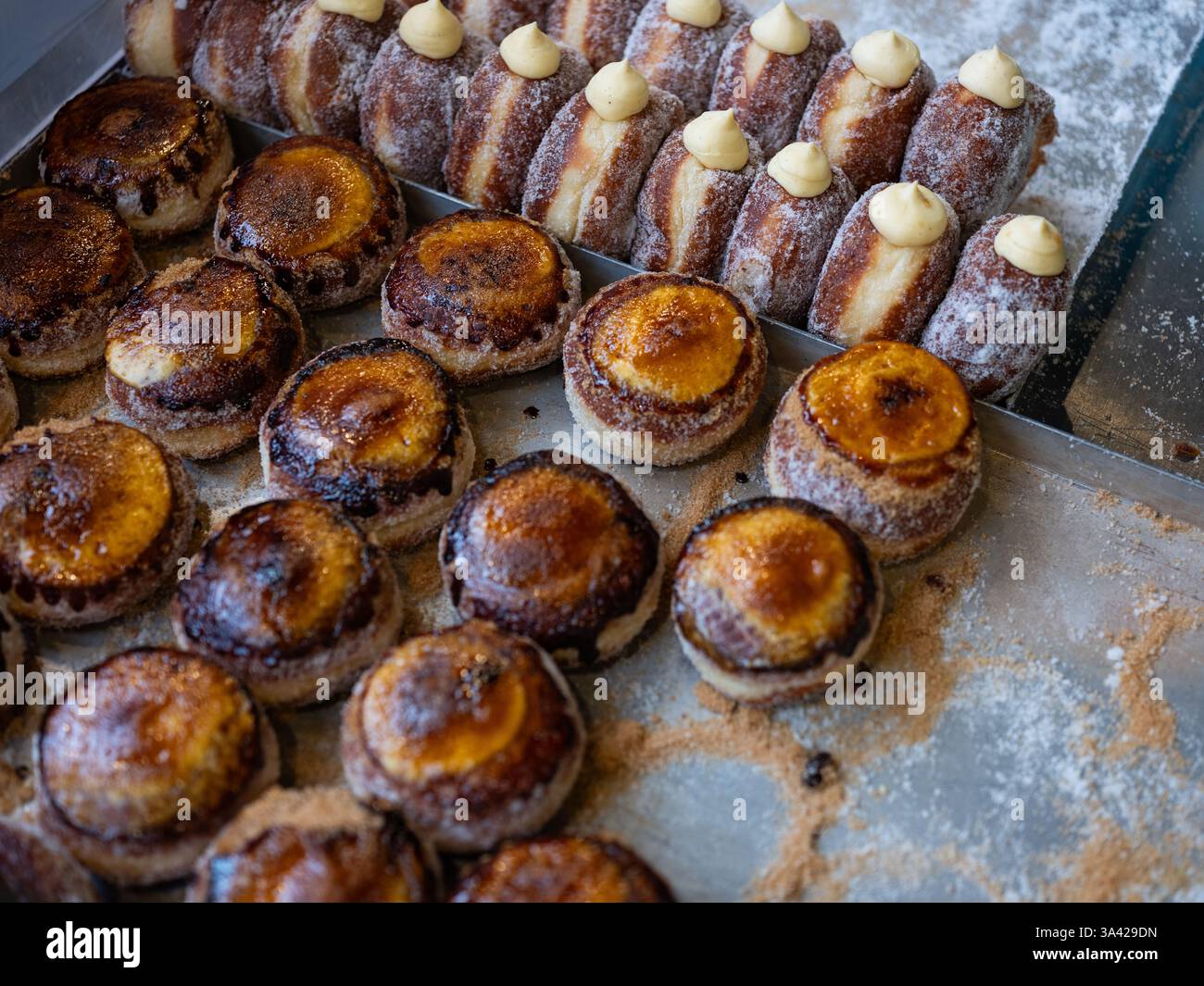 Doughnuts on display on a market stall at Borough Market in London, England, Stock Photo