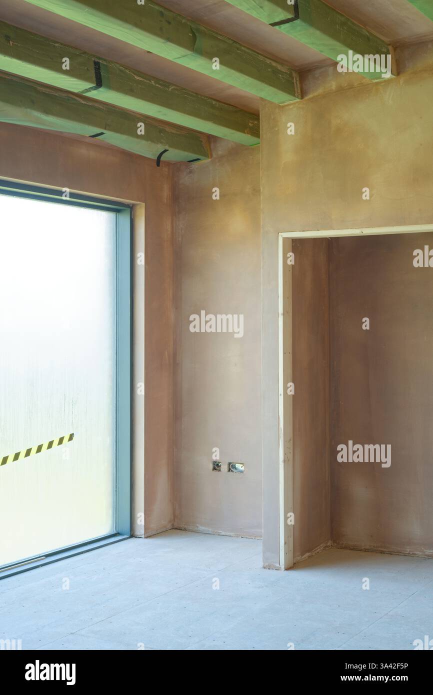 Newly plastered room. Building work finished with a smooth flat surface of thin plaster. A great skill. Stock Photo