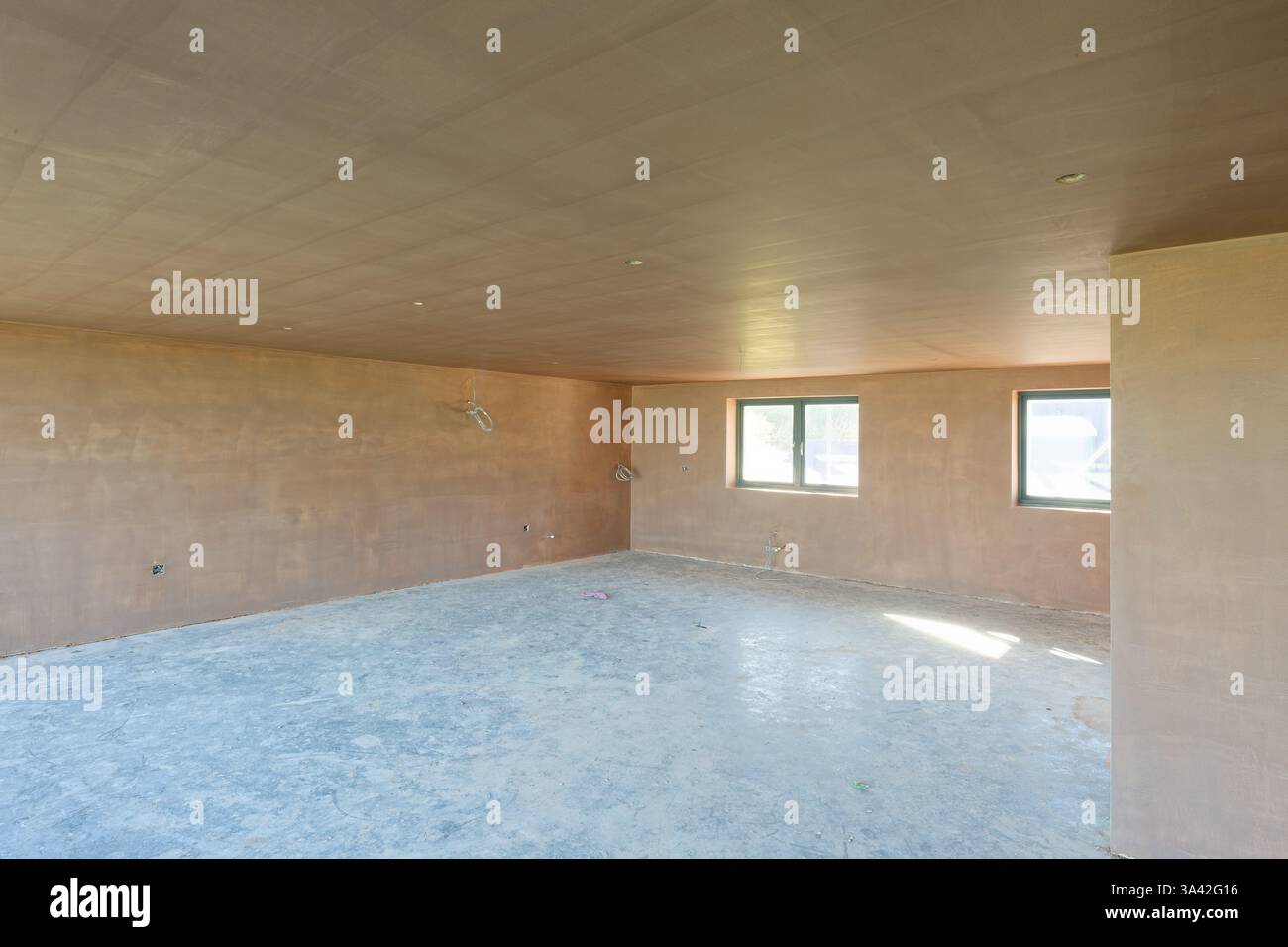 Newly plastered room. An unfinished kitchen. Building work finished with a smooth flat surface of thin plaster. A great skill. Stock Photo
