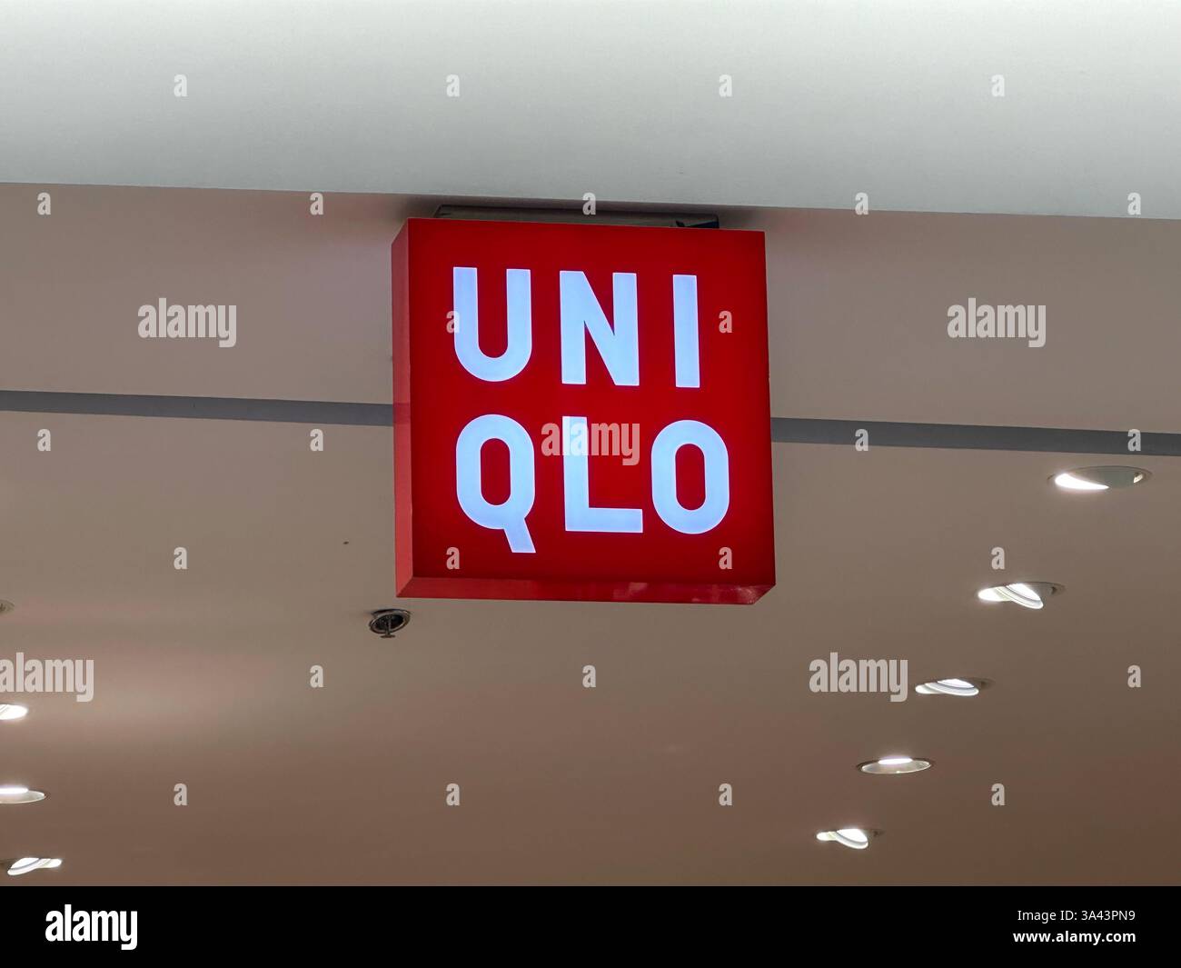 Nanning, China Nov 13, 2023. Uniqlo clothing store logo. Uniclo is a Japanese casual wear designer, manufacturer and retailer. - Smartphone Captured Stock Image