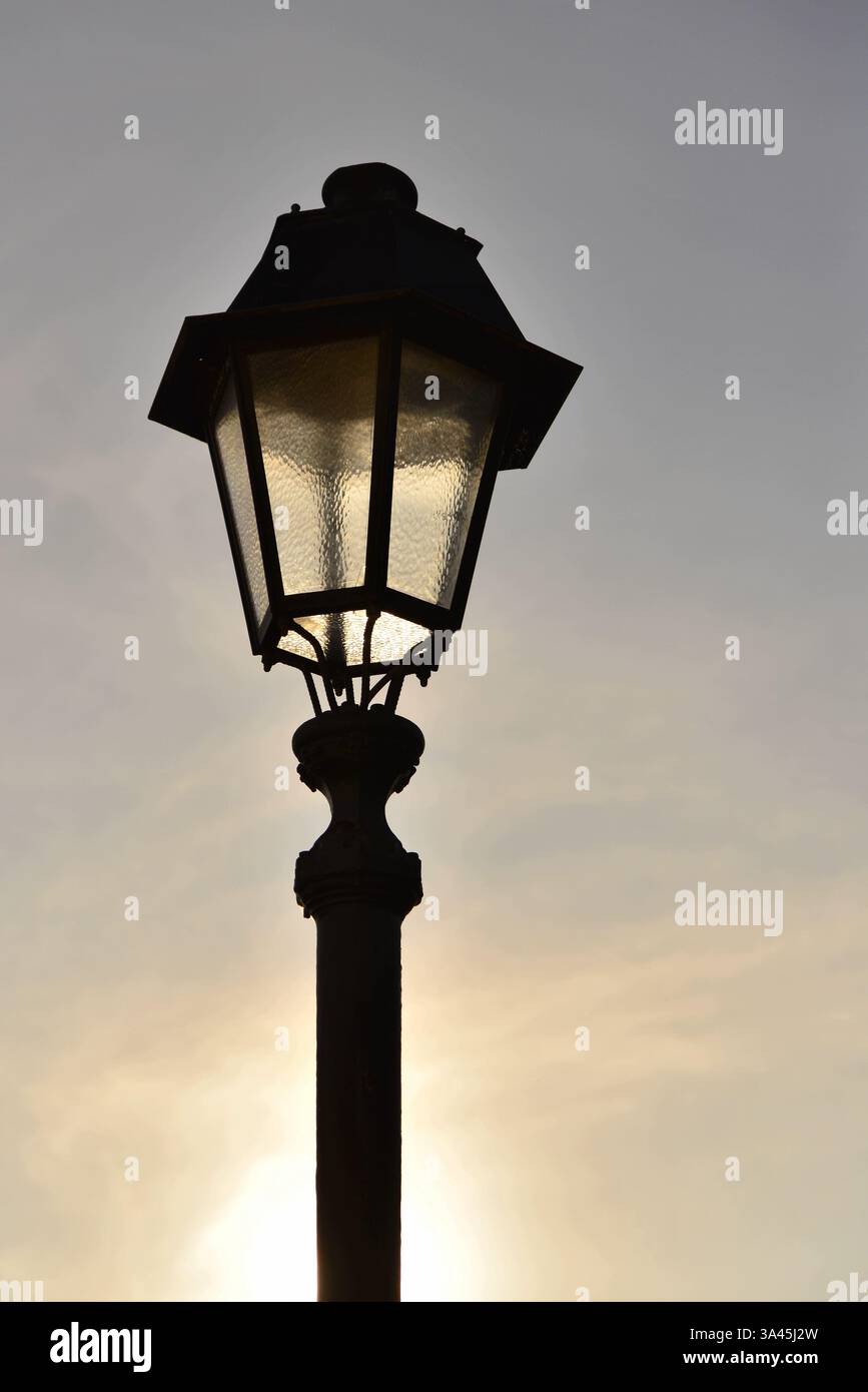 Street light backlit during the daytime Stock Photo - Alamy