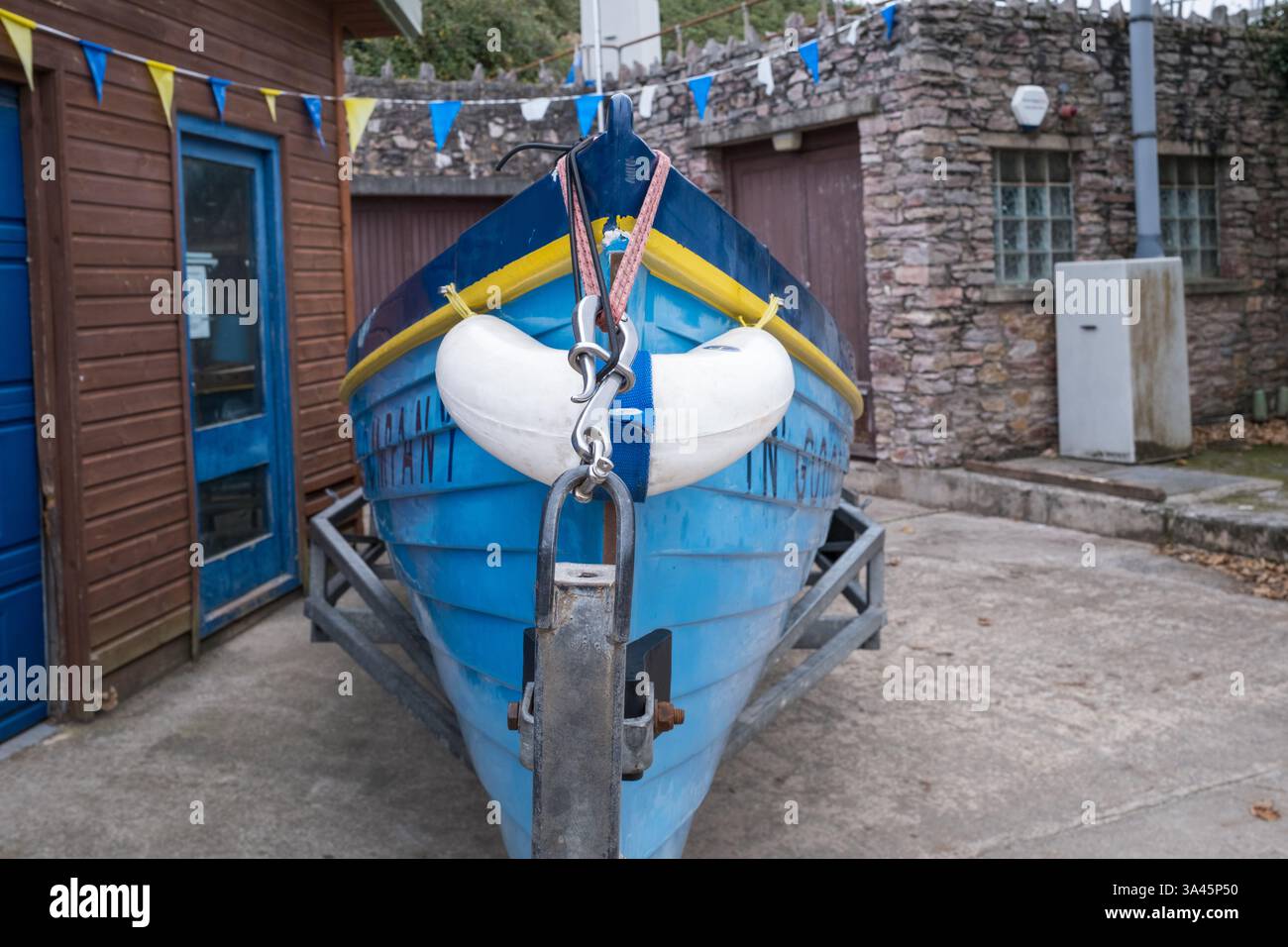 The blue and yellow gig rowing boat belonging to Salcombe Estuary ...