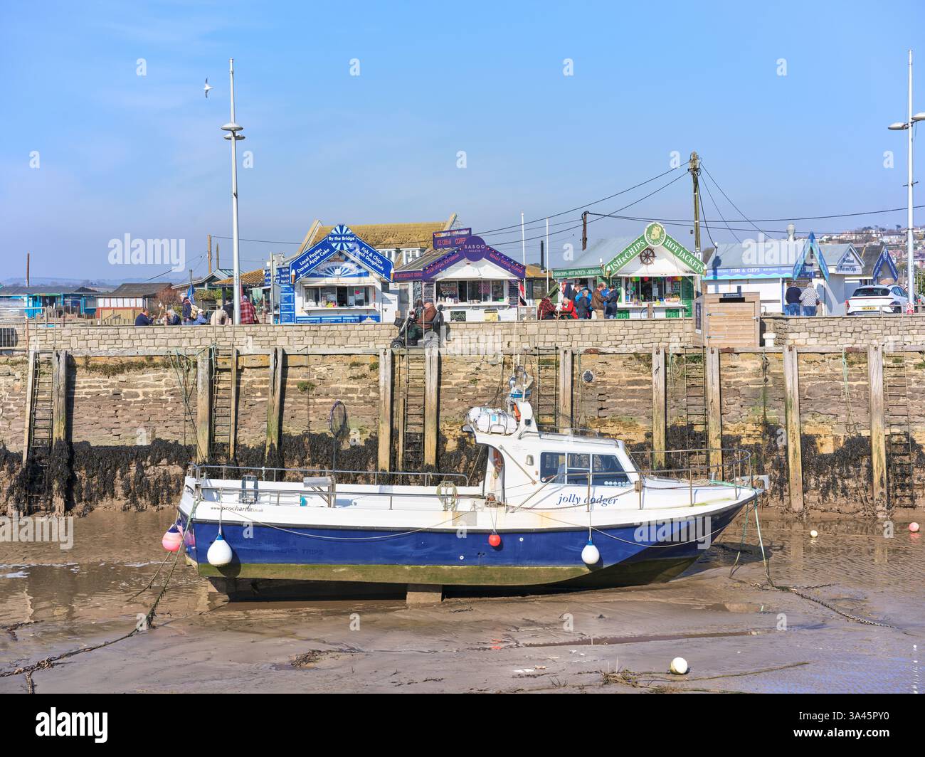 Stranded boat in the harbour at West Bay, England, with the tide out ...