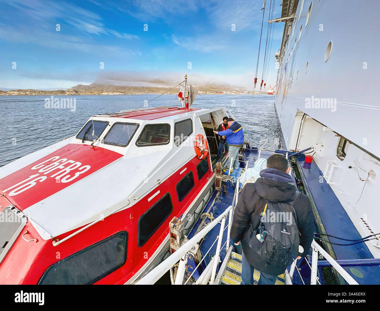Nanortalik, Greenland - 27 August 2024: Passengers descending the gangway of a cruise ship to board a lifeboat to ferry them to the small harbour - Smartphone Captured Stock Image