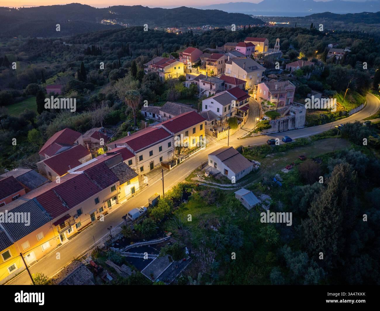 Aerial view reveals a tranquil village nestled among lush greenery ...