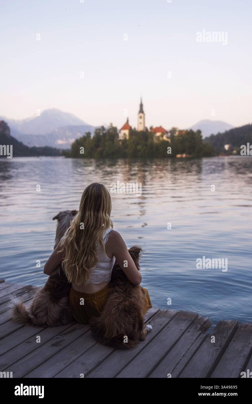 young woman with 2 Miniature Australian Shepherds Stock Photo