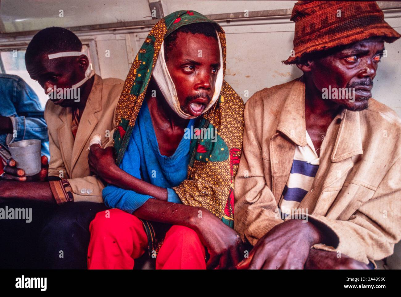 Burundi's ethnic strife', Nov 1993. Displaced Tutsis from the area around Ruyigi take refuge in a camp protected by the army. A severely injured man is brought to hospital. Stock Photo