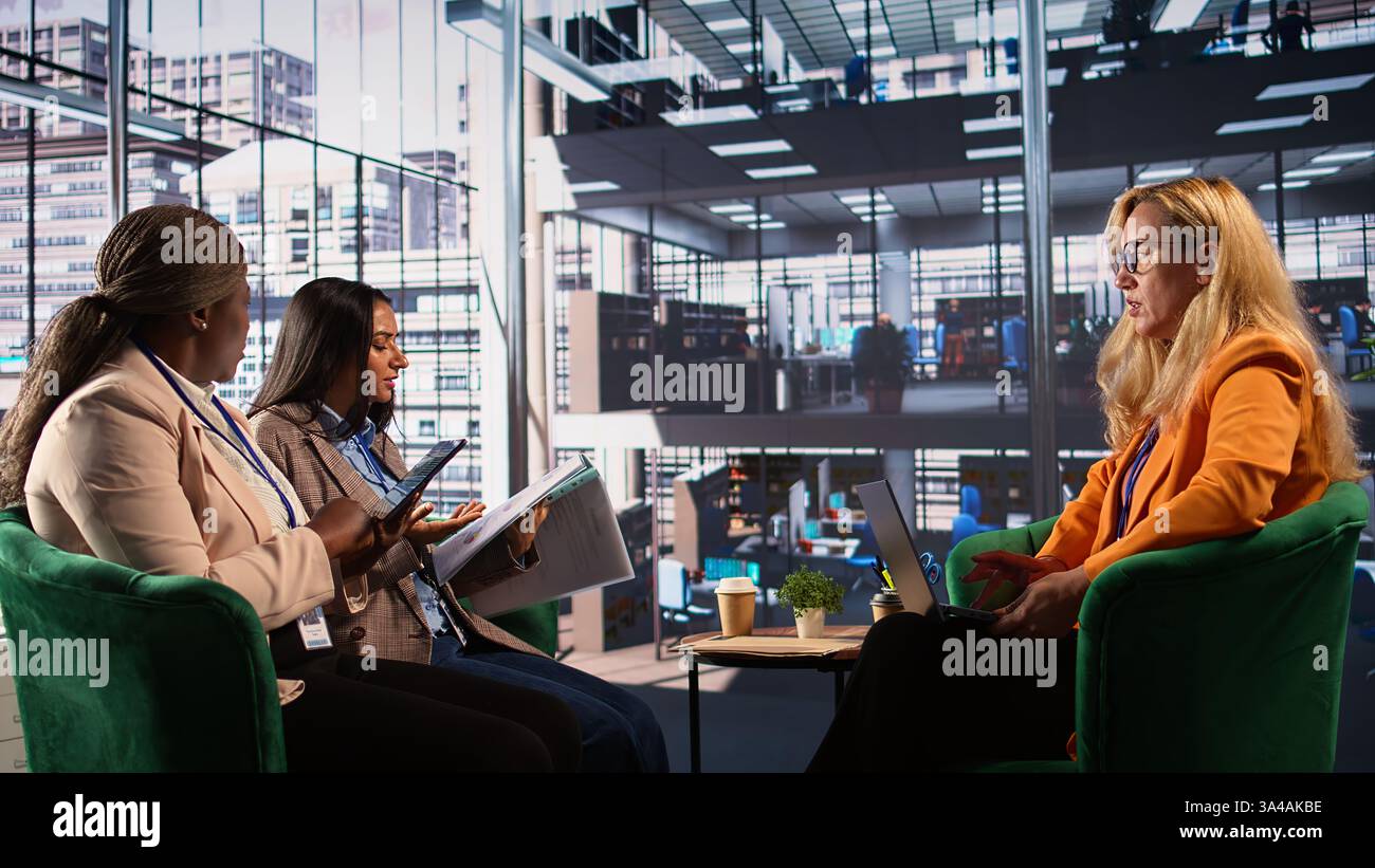 General director reviewing data analytics with her team for successful ...