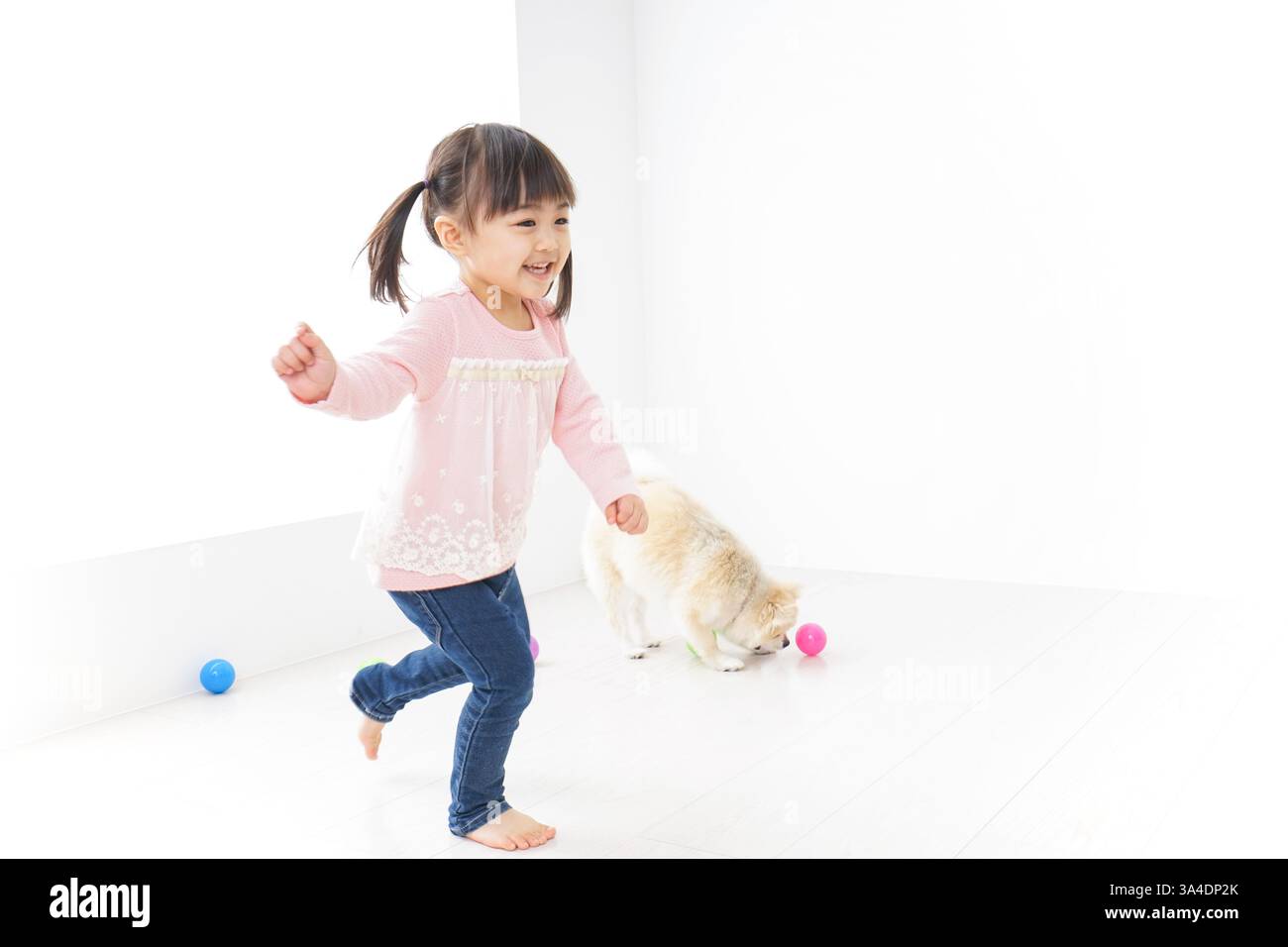 Child playing with dog Stock Photo