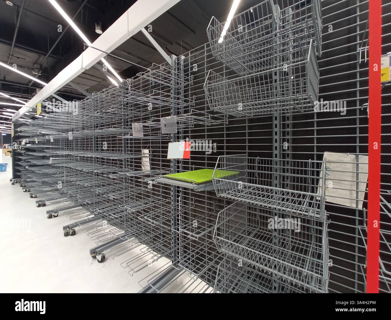 Empty metal store shelves with wire racks Stock Photo - Alamy