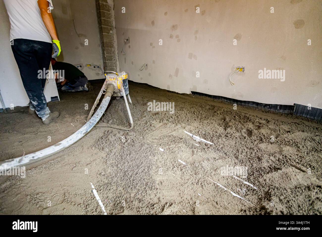 Pump machine throws out mixture of cement and sand, semi-dry floor ...