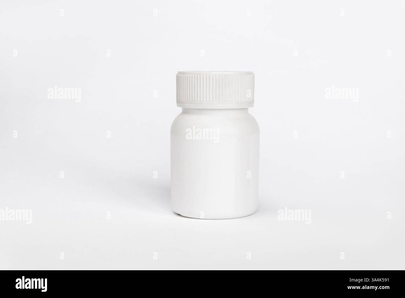 Close up of a plastic white jar with a lid for medicine isolated on a white background. Stock Photo