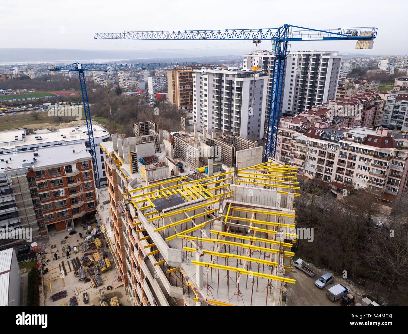 Construction site with a high-rise building under development and two ...