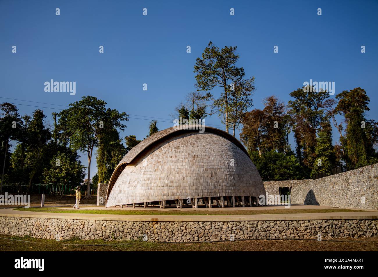 Stunning bamboo dome in Laos surrounded by lush greenery, an architectural marvel ideal for travel and landscape photography Stock Photo
