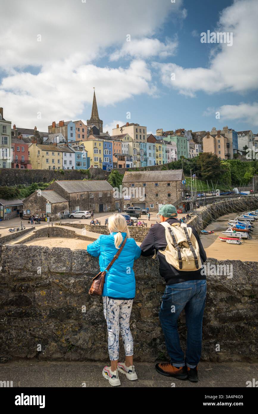 Couple taking in the view over Tenby Harbour in South Wales, UK. Stock Photo