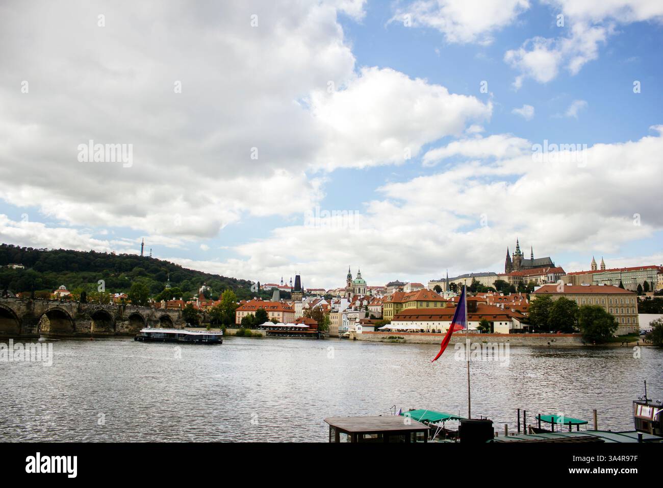 A view from across the river capturing the historic skyline of Prague ...