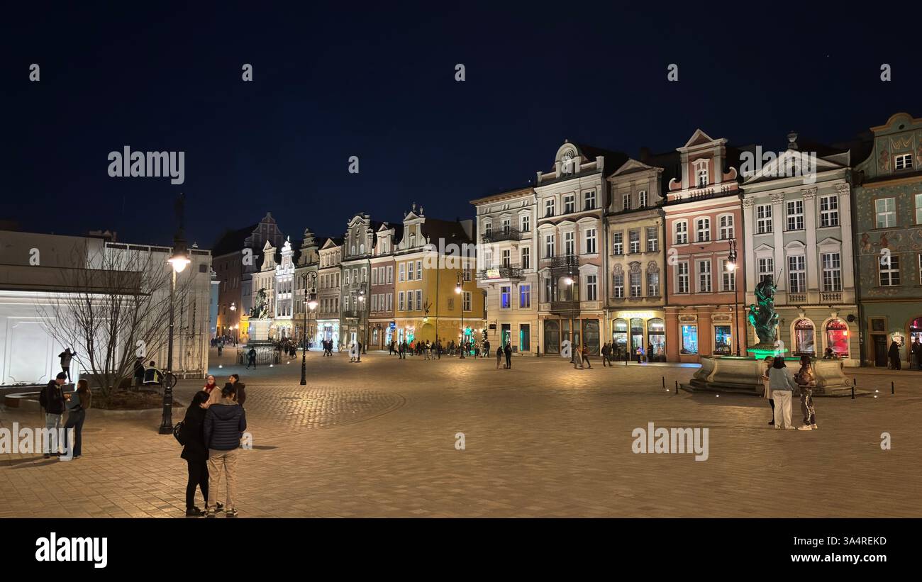 Poznan city centre in the evening. At night darkness streets and buildings illuminated. Location in Poznań. Tourist destination place famous old build - Smartphone Captured Stock Image