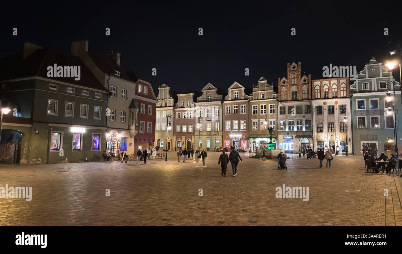 Poznan city centre in the evening. At night darkness streets and buildings illuminated. Location in Poznań. Tourist destination place famous old build - Smartphone Captured Stock Image
