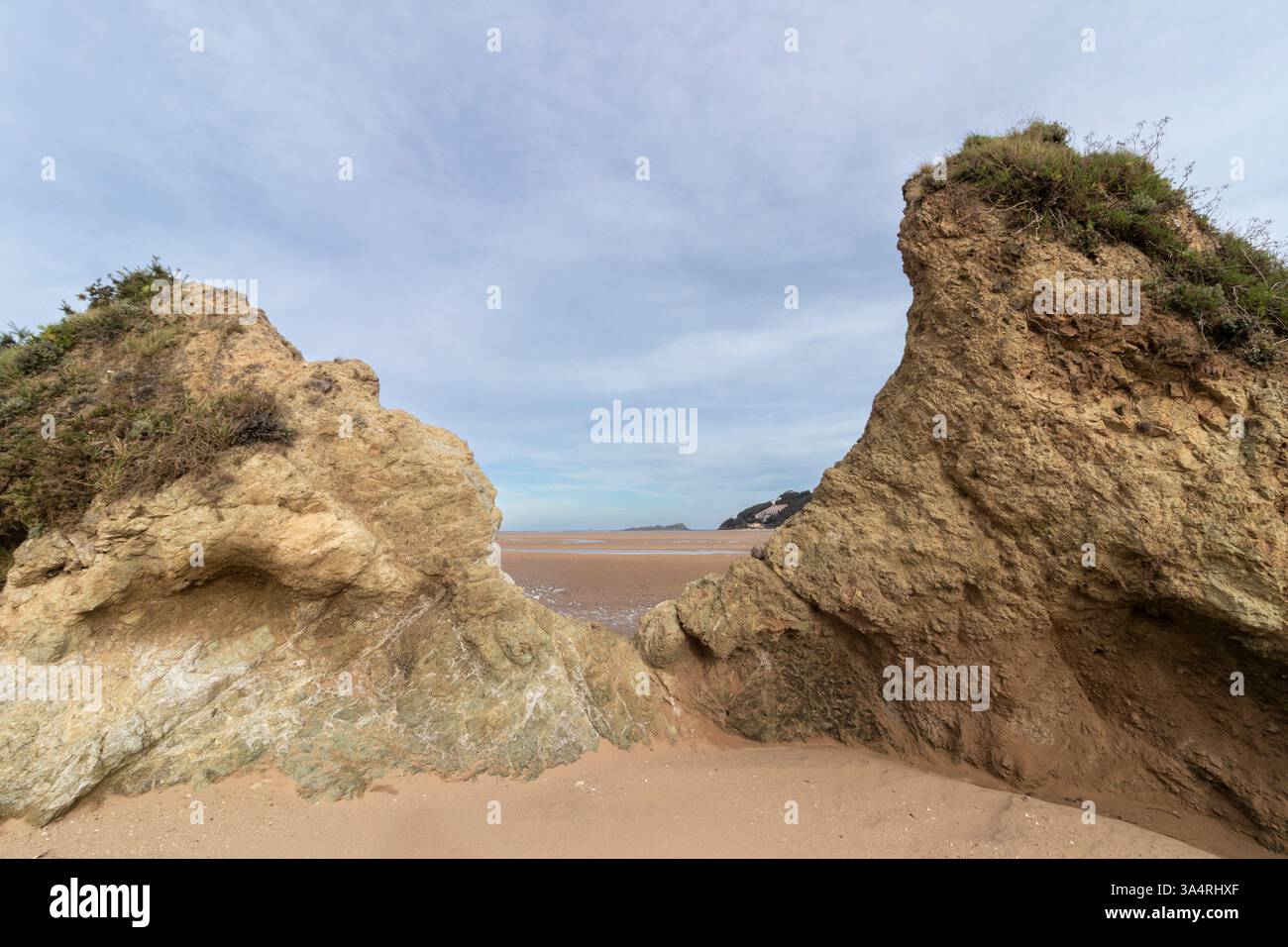 Small Sandy Ridge Sandy beach framed by rugged rock formations, opening to a vast coastal ...